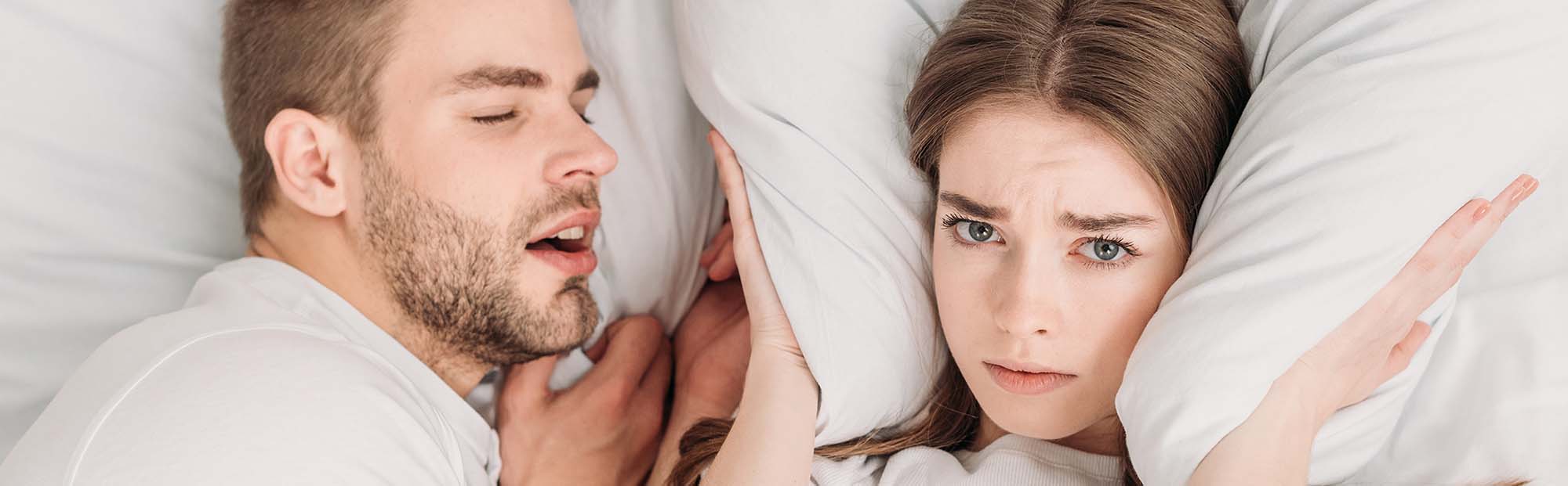 Couple experiencing sleep apnea symptoms
