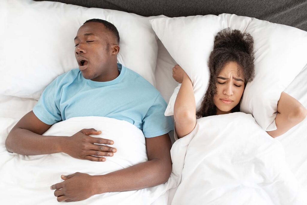 Man suffering from sleep apnea affecting his partner's sleep