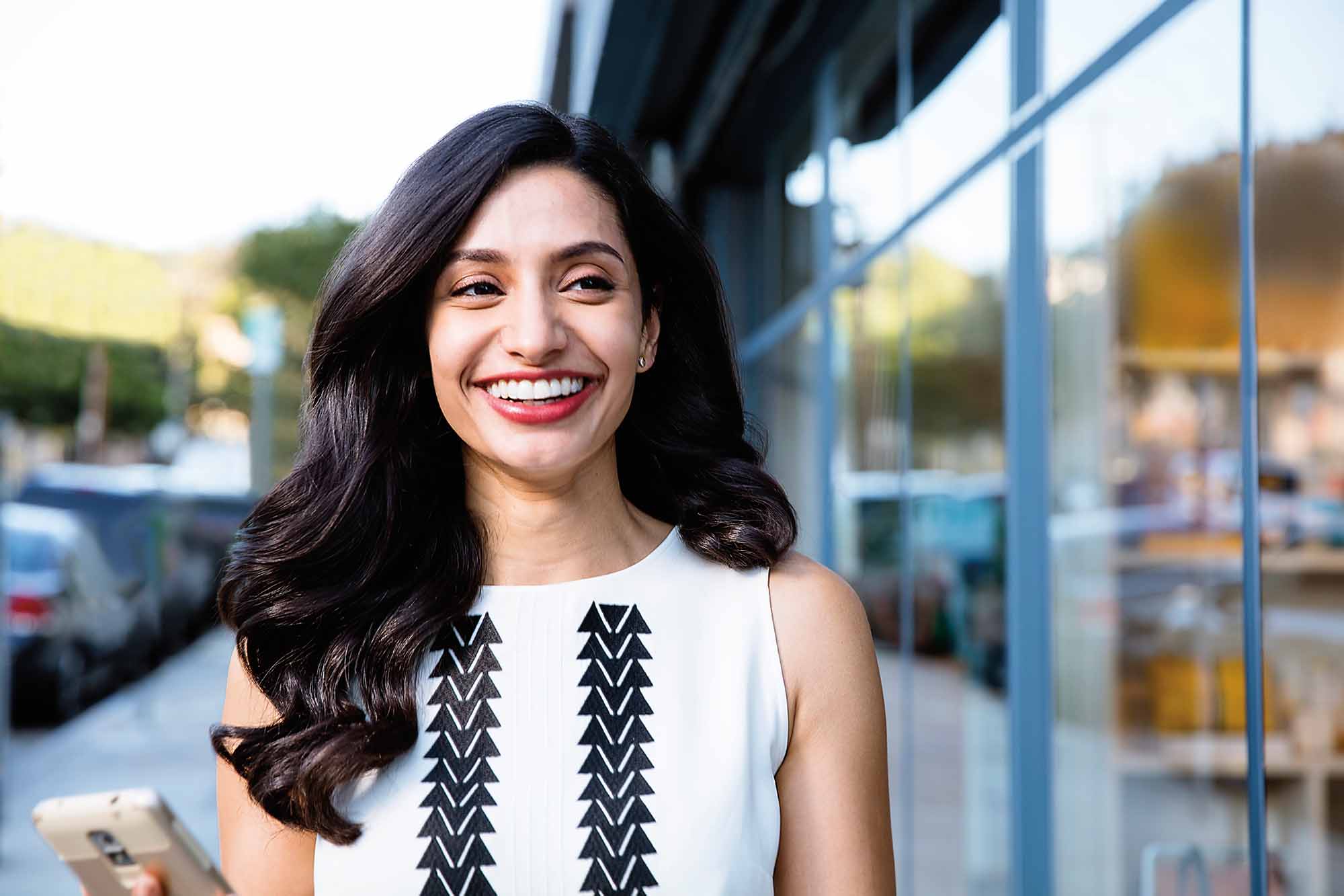 Invisalign confidence: Smiling woman in the city