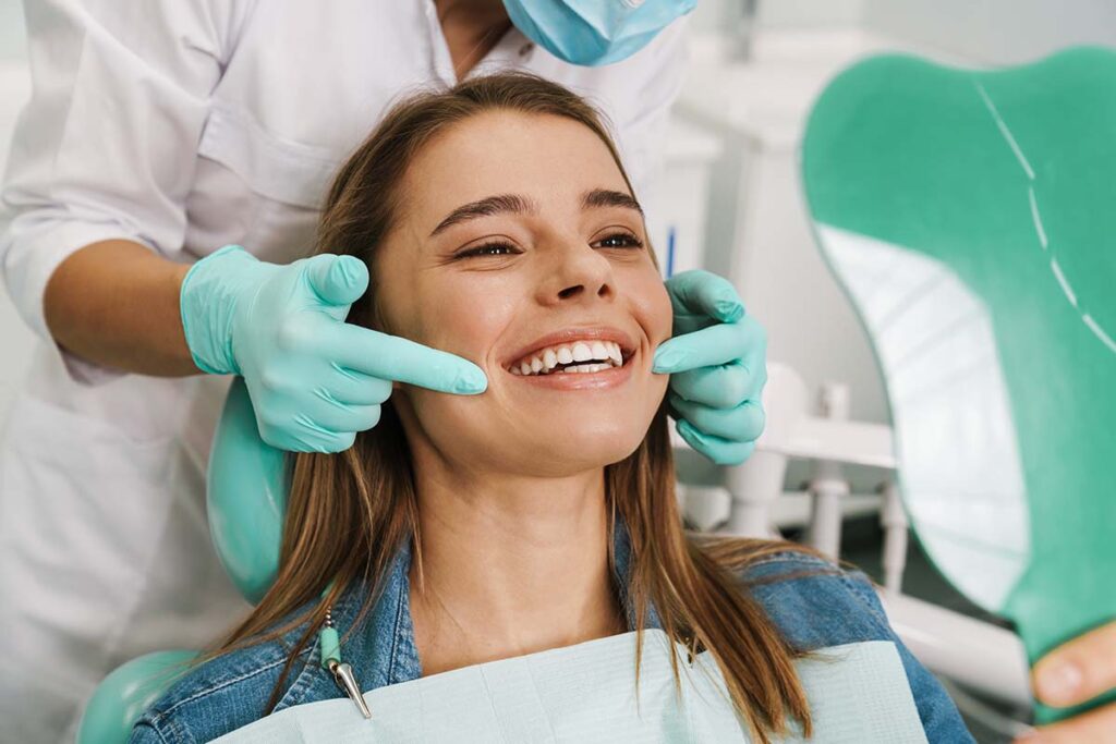 Young woman happy with bright white teeth after whitening